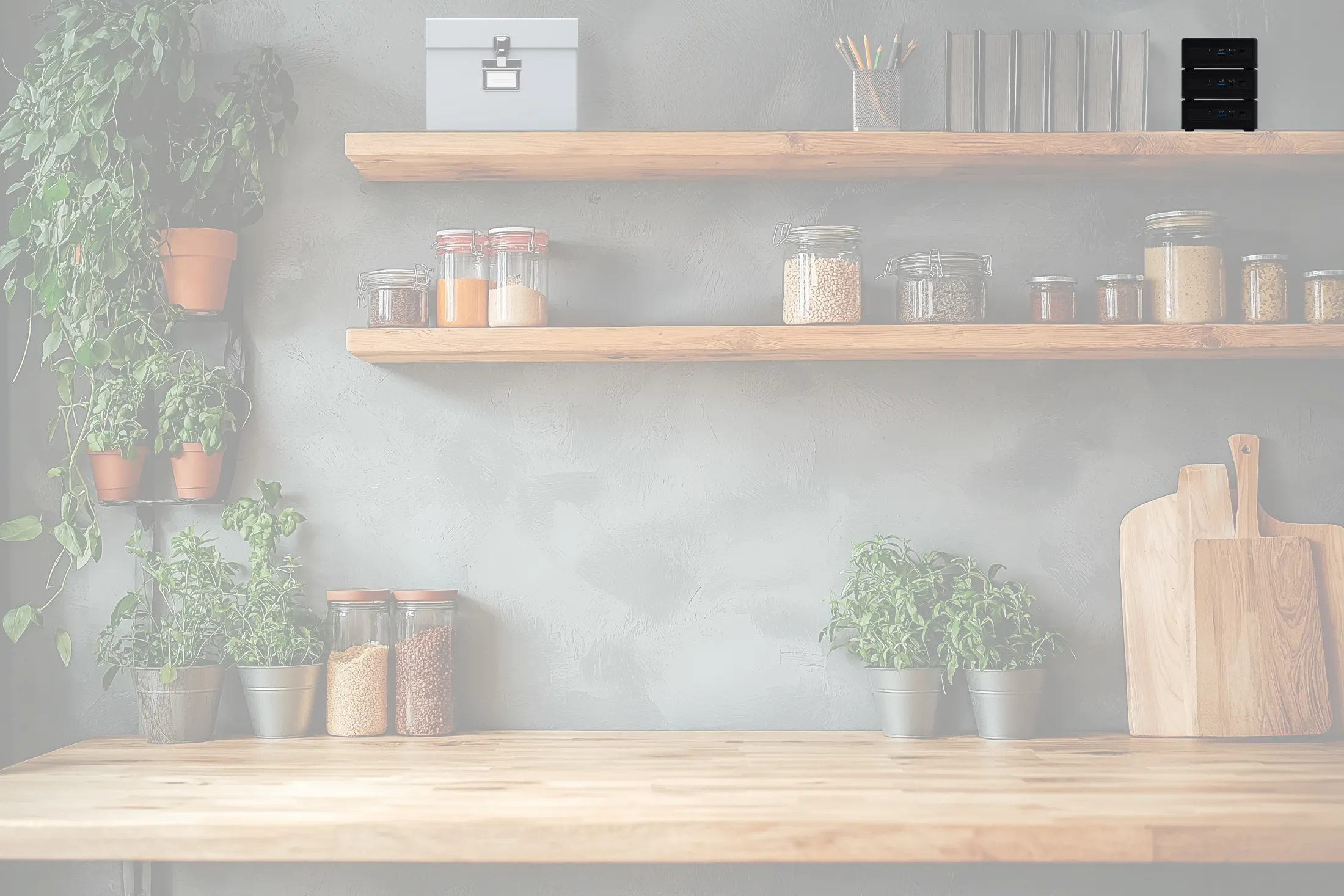 Modern kitchen shelves with jars, herbs, and wooden boards against a gray wall.